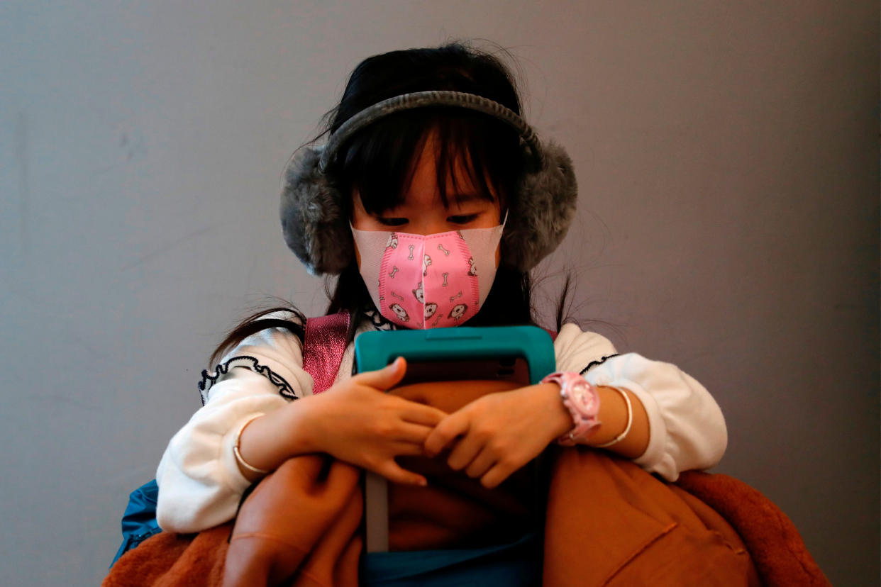 A child wears mask to prevent an outbreak of a new coronavirus at the Hong Kong West Kowloon High Speed Train Station, in Hong Kong, China January 23, 2020. REUTERS/Tyrone Siu     TPX IMAGES OF THE DAY