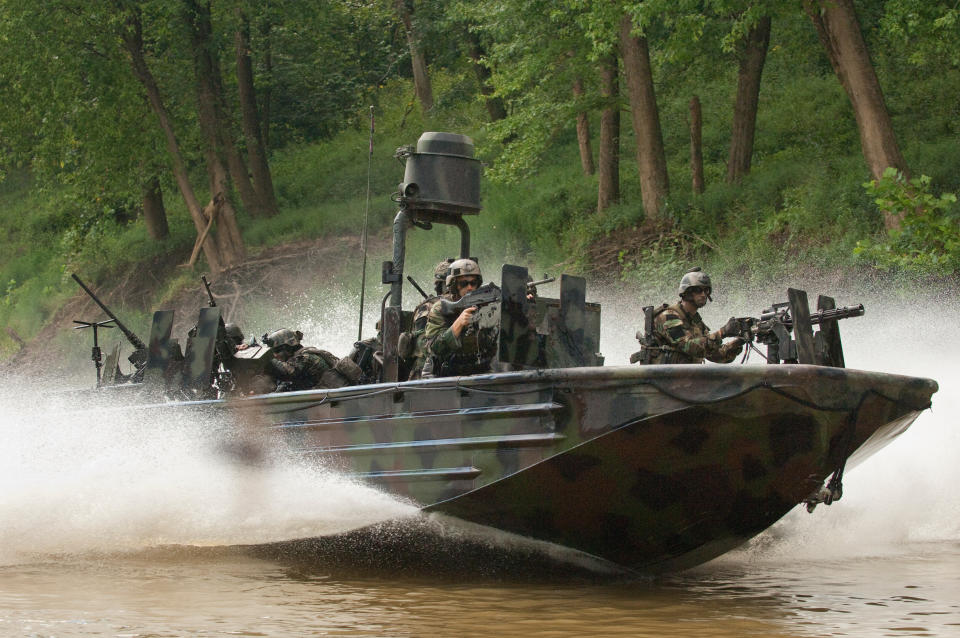 A SOC-R from the Special Boat Team moves at high rate of speed down a narrow waterway as SWCC operators man their weapons.  Photo: Greg E. Mathieson Sr. / NSW Publications, LLC