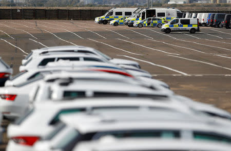 Police vehicles are parked after Greenpeace activists gained access to the vehicle park to protest against Volkswagen diesel vehicles at the port of Sheerness, Britain, September 21, 2017. REUTERS/Peter Nicholls