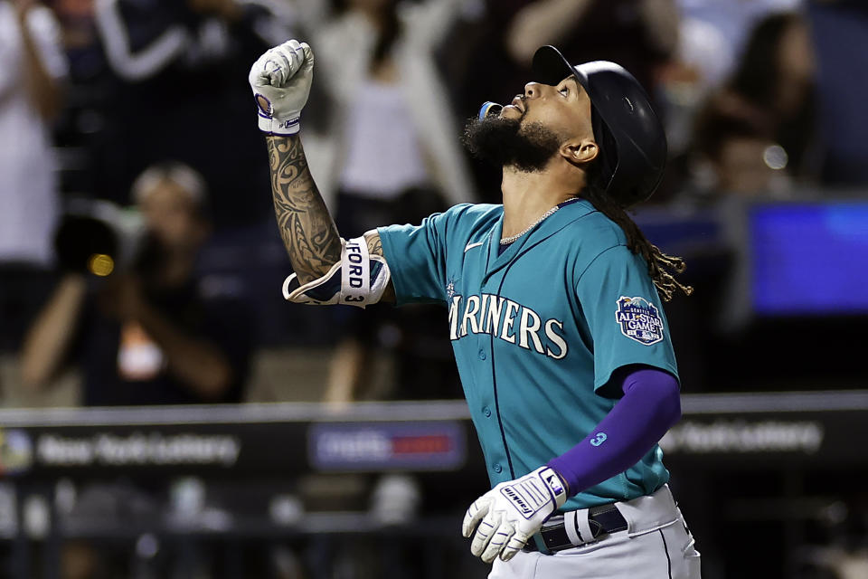 Seattle Mariners' J.P. Crawford gestures after hitting a home run against the New York Mets during the fourth inning of a baseball game Friday, Sept. 1, 2023, in New York. (AP Photo/Adam Hunger)