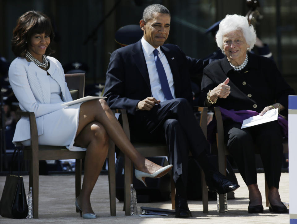 President Barack Obama and First Lady Michelle Obama watch as former first lady Barbara Bush gives the thumbs up to guests during the dedication of the George W. Bush presidential library on Thursday, April 25, 2013, in Dallas. (AP Photo/David J. Phillip)