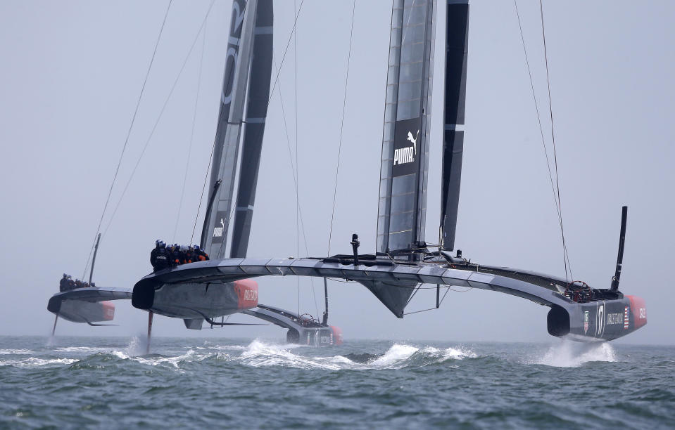 Both Oracle Team USA AC72 catamarans make their way through the fog during training for the America's Cup, Wednesday, July 3, 2013, in San Francisco. Opening ceremonies for the sailing event are scheduled for Thursday. (AP Photo/Eric Risberg)