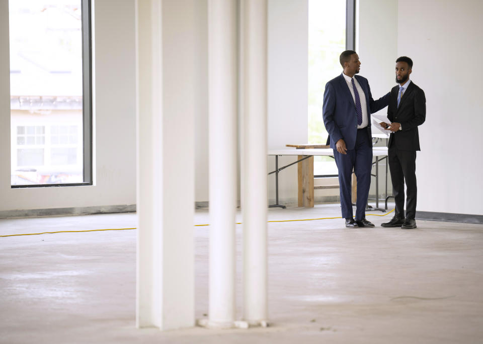 Nasri Warsame consults with his campaign manager, Abshir Omar, left, before they both appeared at a news conference Wednesday, May 17, 2023. After a wild Ward 10 DFL convention last weekend, challenger Nasri Warsame alleged bias and rules violations against his campaign at a news conference at his campaign headquarters in Minneapolis Wednesday afternoon, May 17, 2023. (Jeff Wheeler/Star Tribune via AP)