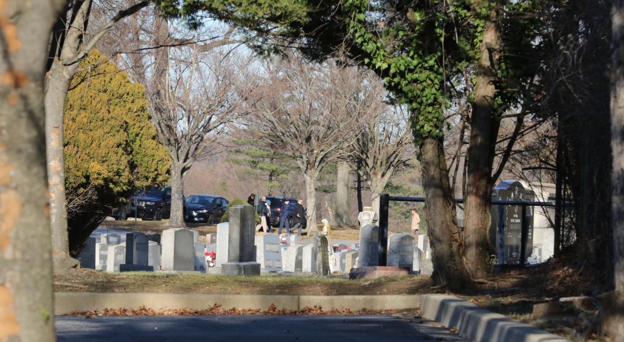 Investigators walk toward the grave site of 20-year-old Joyce Malecki, who was found murdered in 1969.