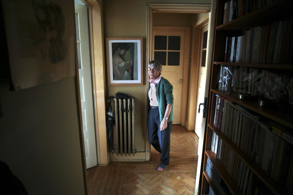 In this Sept. 24, 2012 photo, Teresa Dourado, poses for a photograph at her home in Lisbon. The peaceful retirement of Teresa Dourado is about to be shattered. The 77-year-old widow raised two children with her husband in their fourth-floor apartment behind Lisbon's Campo Pequeno bull-ring. It has been the family home since 1966. Living alone there now among black-and-white photographs of her children and with her husband's framed paintings, she pays a controlled rent of euro 100 ($128) a month. That just about allows her to get by on her monthly pension of euro 414. (AP Photo/Francisco Seco)