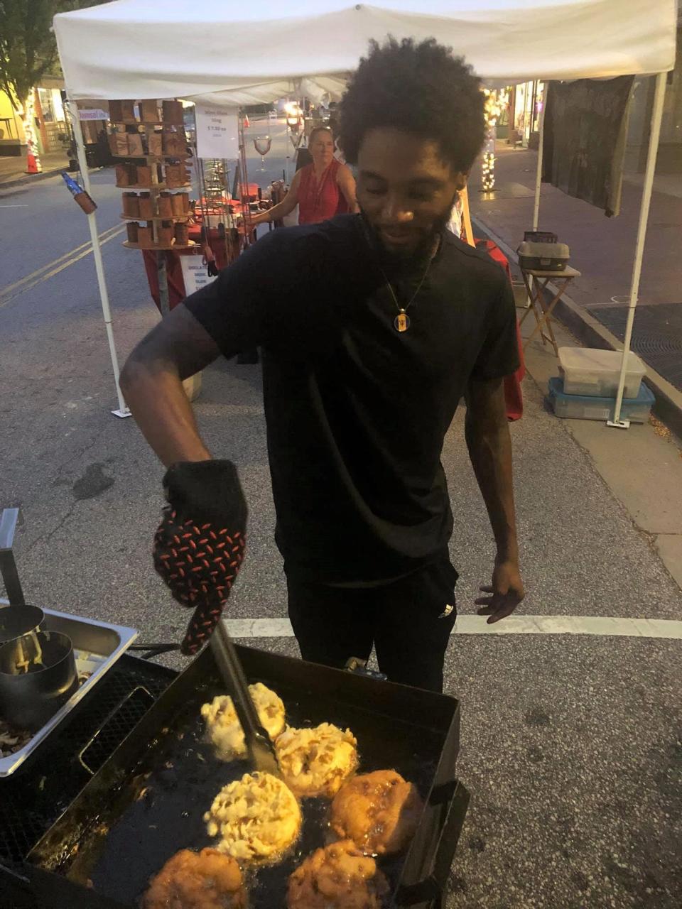 Cason Funnel Cakes owner Andre Cason makes funnel cakes at the 'Third Thursdays' street festival in Downtown Hopewell on September 16, 2021.