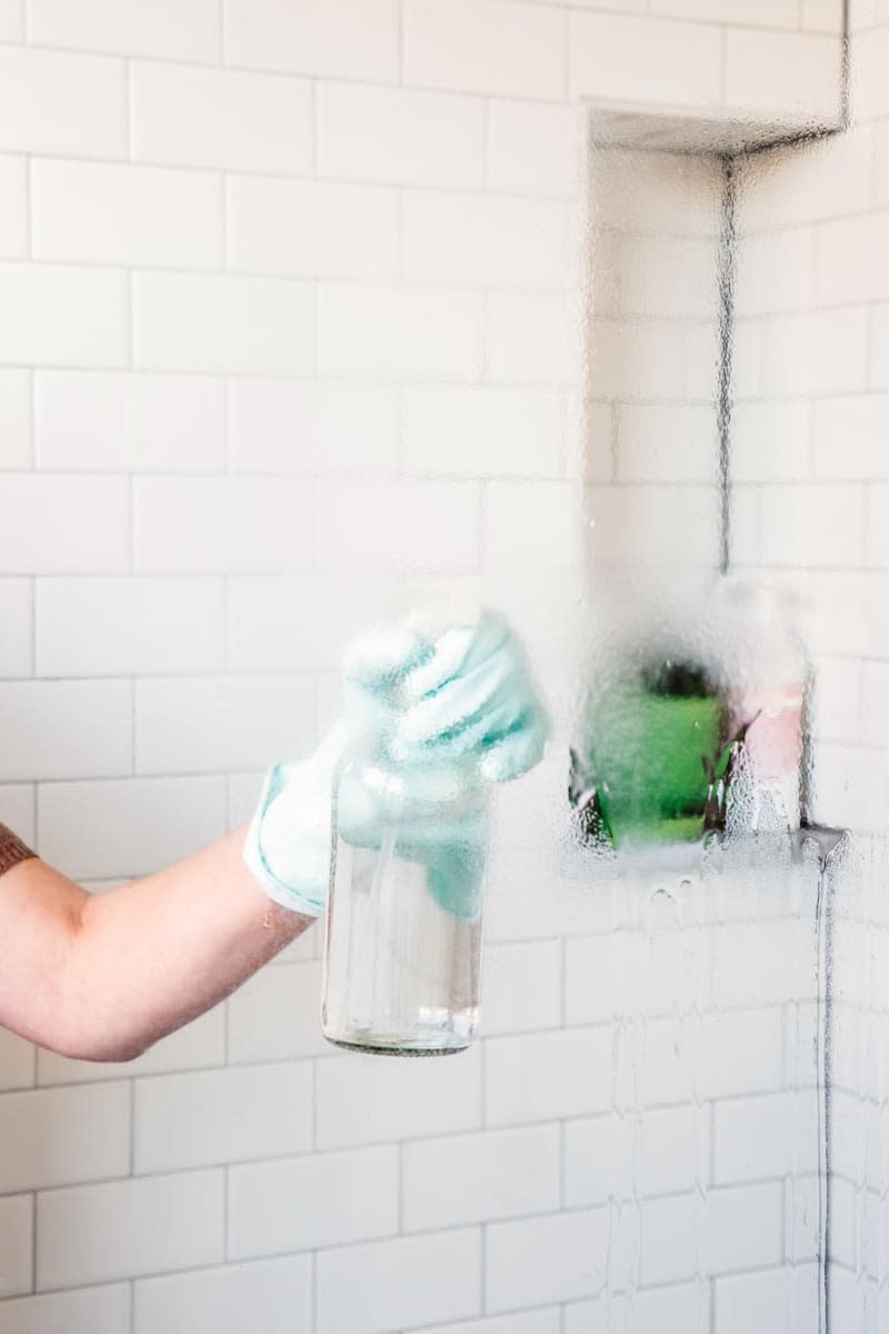 Spraying shower door with an ammonia solution