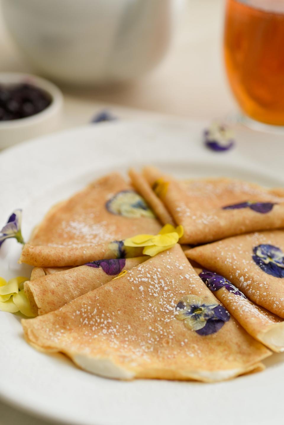 Viola Crepes include edible flowers and cream filling.
