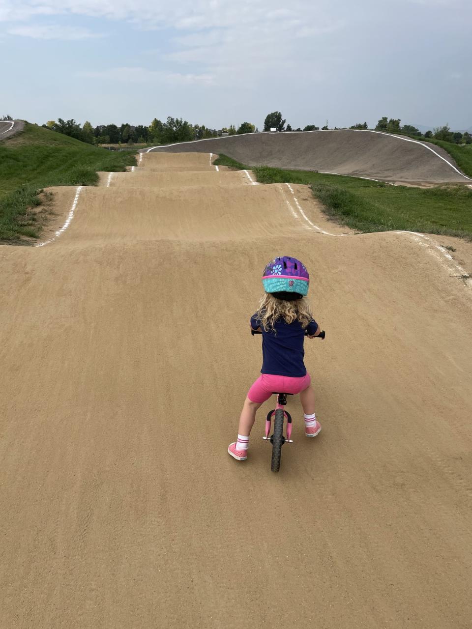 The author's daughter riding a bike