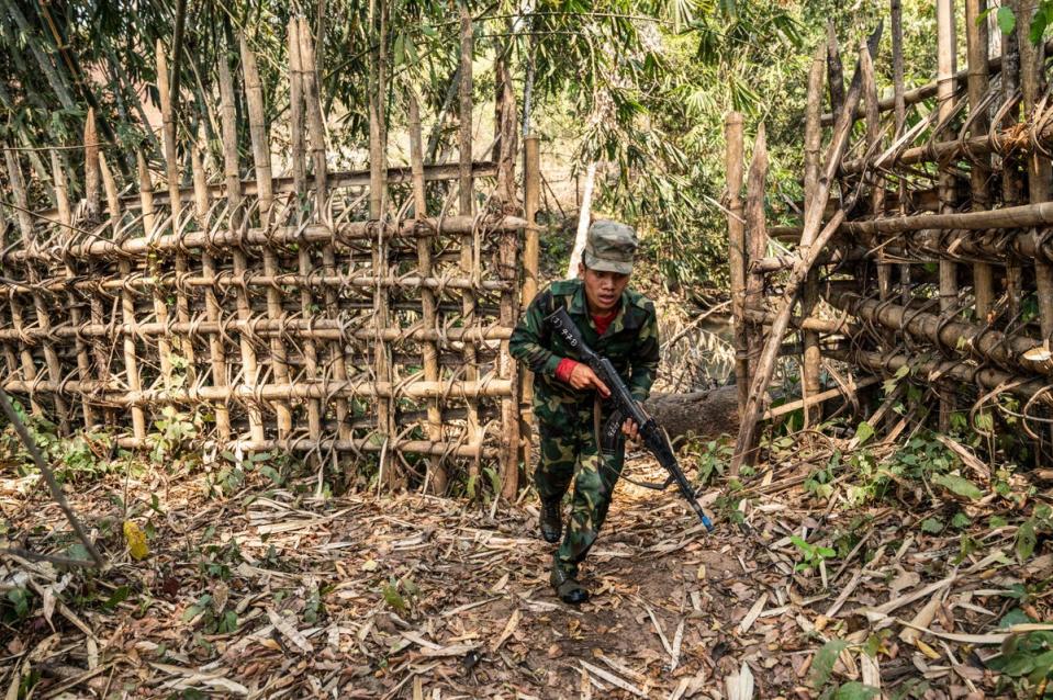 a member of ethnic rebel group Ta’ang National Liberation Army (TNLA) takes part in a training exercise at his base camp in the forest in Myanmar (AFP via Getty Images)