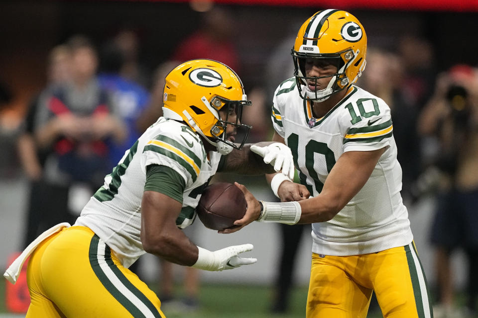 Green Bay Packers quarterback Jordan Love (10) hands the balll to Green Bay Packers running back AJ Dillon (28) during the first half of an NFL football game against the Atlanta Falcons, Sunday, Sept. 17, 2023, in Atlanta. (AP Photo/Brynn Anderson)