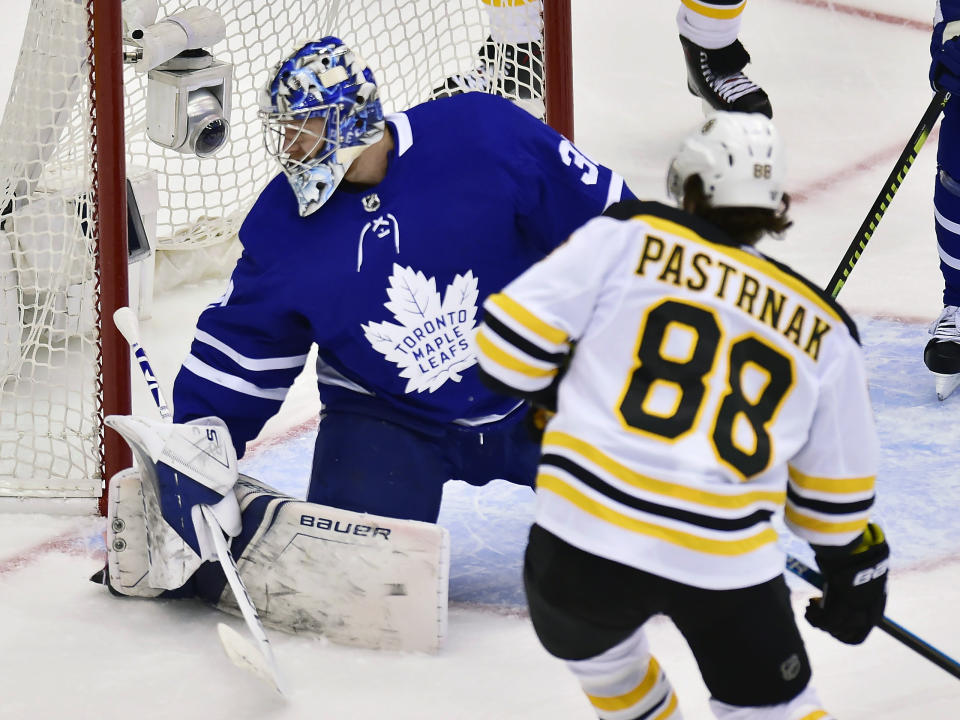 Toronto Maple Leafs goaltender Frederik Andersen (31) looks for the puck as Boston Bruins right wing David Pastrnak (88) scores during the second period of Game 4 of an NHL hockey first-round playoff series Wednesday, April 17, 2019, in Toronto. (Frank Gunn/The Canadian Press via AP)