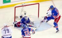 May 22, 2014; New York, NY, USA; Montreal Canadiens center Alex Galchenyuk (27) scores the game-winning goal past New York Rangers goalie Henrik Lundqvist (30) and defenseman Marc Staal (18) during the overtime period in game three of the Eastern Conference Final of the 2014 Stanley Cup Playoffs at Madison Square Garden. Ed Mulholland-USA TODAY Sports