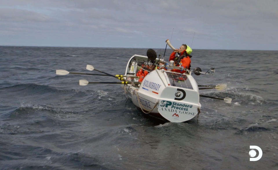 This image released by Discovery Channel shows Icelandic ocean rower Fiann Paul blowing a horn in a scene from “The Impossible Row," documenting endurance athlete Colin O’Brady and his crew's crossing of the treacherous icy waters of The Drake Passage by row boat. Located between the Southern tip of South America and the edge of Antarctica the Drake Passage is considered one of the most terrifying and dangerous sea paths in the world. They finished crossing the Drake Passage in 13 days. (Discovery Channel via AP)