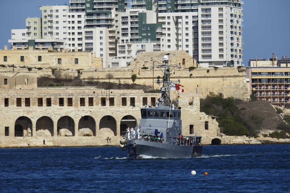 An AFM patrol boat carrying rescued migrants approaches the AFM Maritime Squadron base at Haywharf in Valletta's Marsamxett Harbour