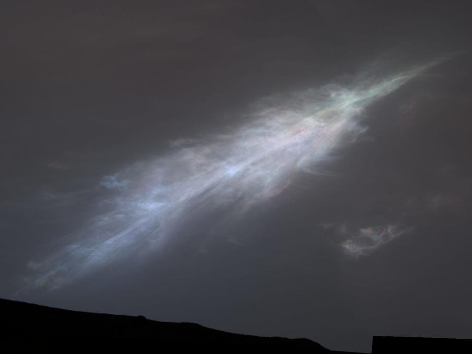 image of iridescent feather-shaped cloud over Mars