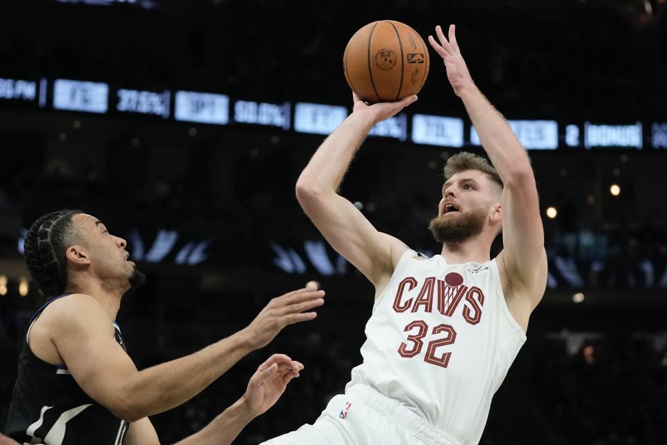 Cleveland Cavaliers' Dean Wade shoots over Milwaukee Bucks' Jordan Nwora during the first half of an NBA basketball game Friday, Nov. 25, 2022, in Milwaukee. (AP Photo/Morry Gash)