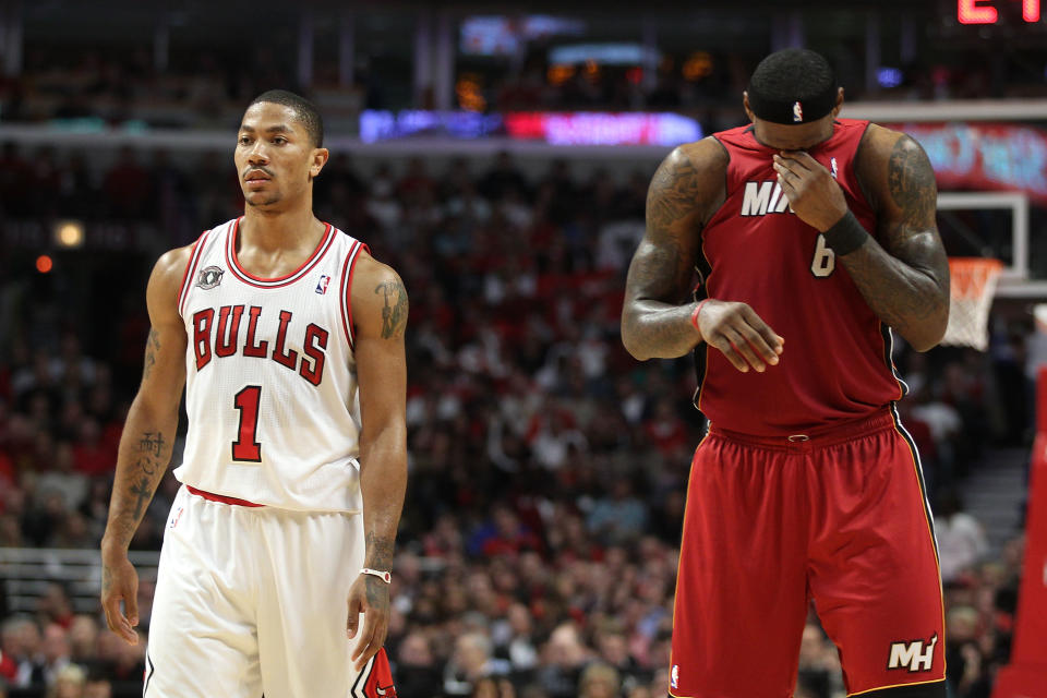 CHICAGO, IL - MAY 26: (L-R) Derrick Rose #1 of the Chicago Bulls looks on as LeBron James #6 of the Miami Heat wipes his face with his jersey in Game Five of the Eastern Conference Finals during the 2011 NBA Playoffs on May 26, 2011 at the United Center in Chicago, Illinois. NOTE TO USER: User expressly acknowledges and agrees that, by downloading and or using this photograph, User is consenting to the terms and conditions of the Getty Images License Agreement. (Photo by Mike Ehrmann/Getty Images)