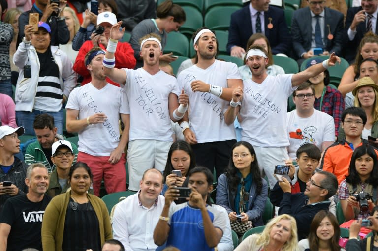 Fans of Britain's Marcus Willis sing in the crowd before the start of the men's singles second round match between Roger Federer and Willis, at Wimbledon on June 29, 2016