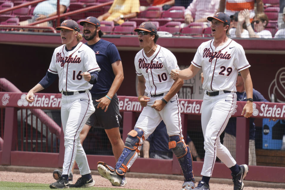 Virginia's Andrew Abbott (16), Tate Ballestero (10), and Zach Messinger (29) react to an inning ending out in the top of the seventh inning during an NCAA college baseball tournament super regional game against Dallas Baptist Sunday, June 13, 2021, in Columbia, S.C. Virginia won 4-0. (AP Photo/Sean Rayford)