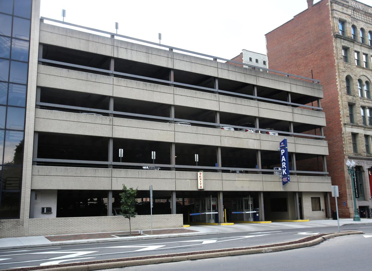 A parking deck on the west side of Market Avenue S, is attached to the Huntington office building by a skywalk over the street.