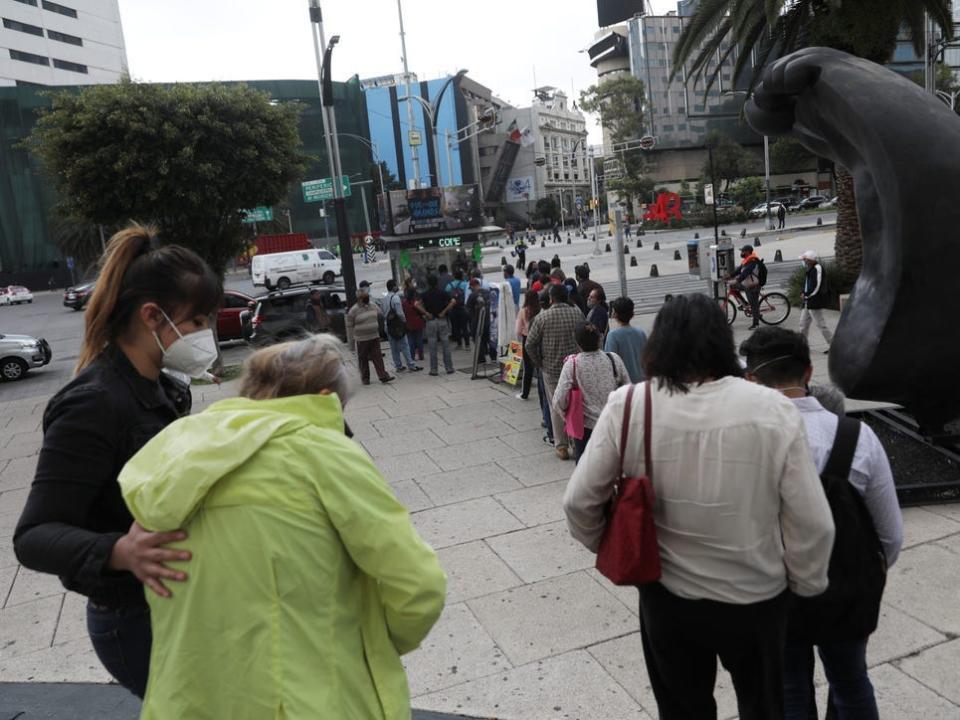 People queue up to buy lottery tickets for a Mexico luxury presidential plane for sale at a raffle ticket booth in Mexico City.