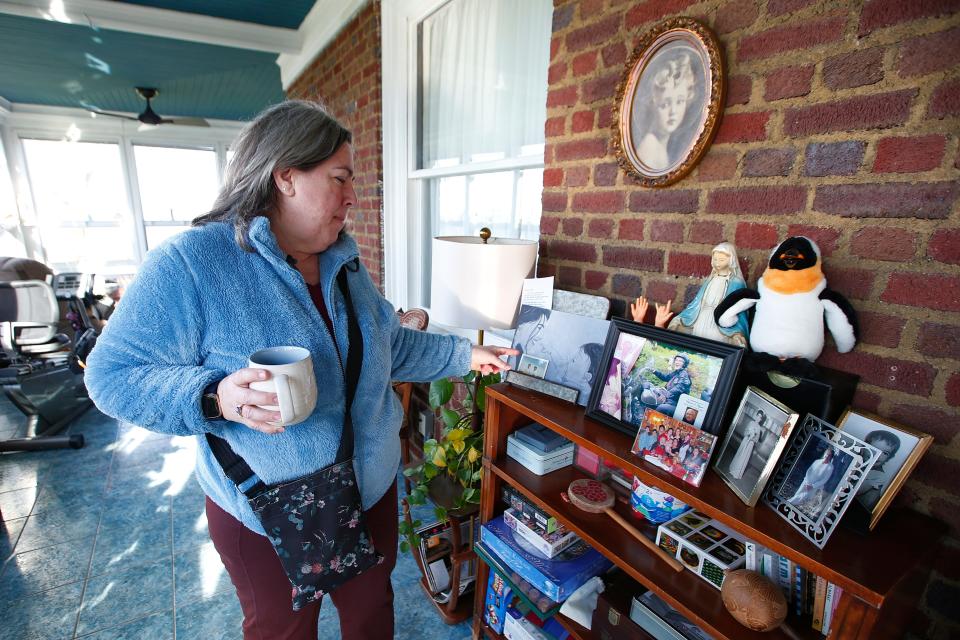 Anita Regan, owner of the former Westview Mansion at the intersection of Main Street and Church Street in Fairhaven, points out some of the people who inspired her to convert the home into a home care facility.
(Credit: PETER PEREIRA/The Standard-Times)