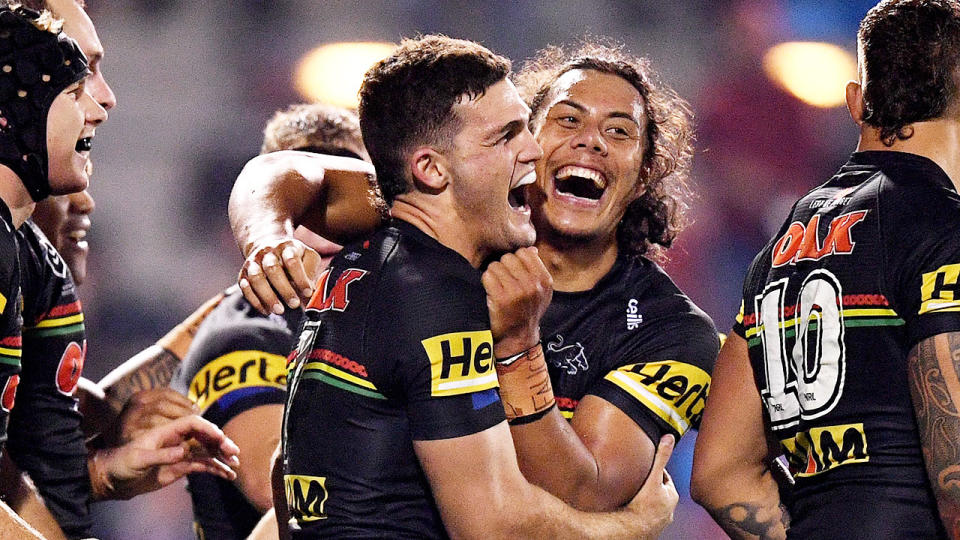 Penrith halves duo Nathan Cleary and Jarome Luai are seen here celebrating together in a match.