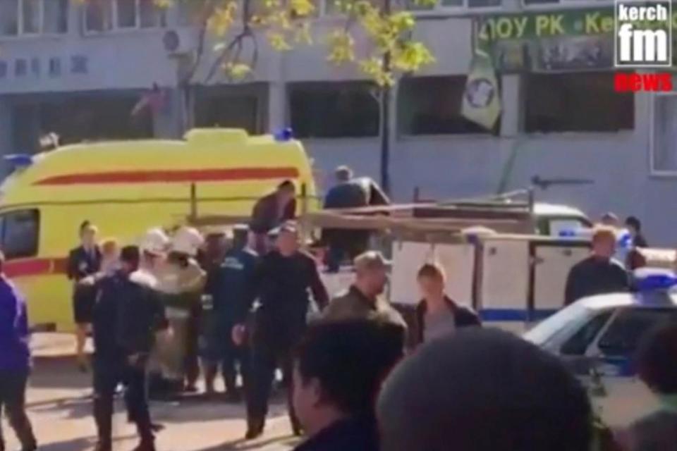 Emergency services load an injured person onto an ambulance in Kerch, Crimea (AP)