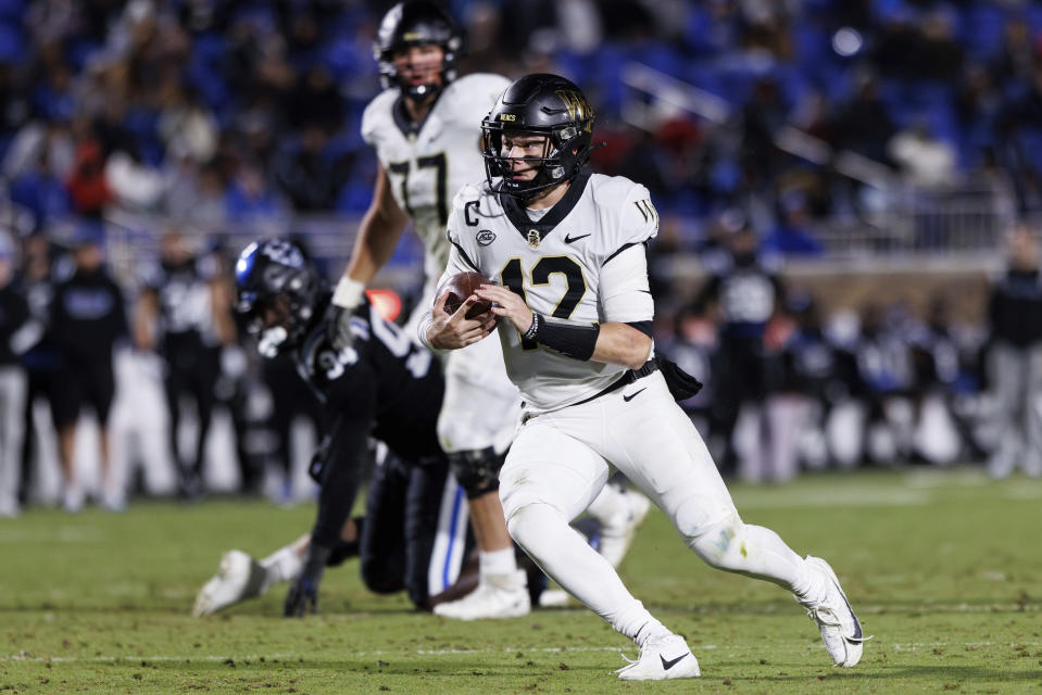 Wake Forest's Mitch Griffis (12) carries the ball during the first half of an NCAA college football game against Duke in Durham, N.C., Thursday, Nov. 2, 2023. (AP Photo/Ben McKeown)