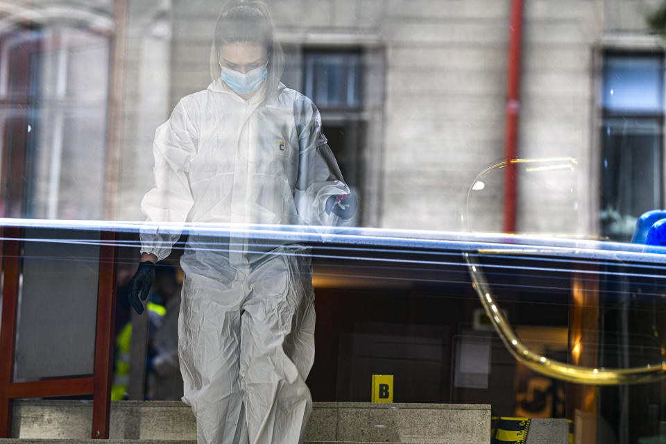 A forensic worker collects body parts and evidence from a hotel downtown Bucharest, Romania, Friday, June 19, 2020. Gholamreza Mansouri, a former judge from Iran sought by his country to face corruption charges has died after falling from a high floor inside a hotel. Romanian police said only that a man had fallen from a high floor at a hotel in Bucharest, the Romanian capital, and was found dead. (AP Photo/Andreea Alexandru)