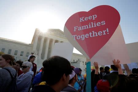 Immigration activists rally outside the U.S. Supreme Court as justices hear arguments in a challenge by 26 states over the constitutionality of President Barack Obama's executive action to defer deportation of certain immigrant children and parents who are in the country illegally in Washington April 18, 2016. REUTERS/Joshua Roberts