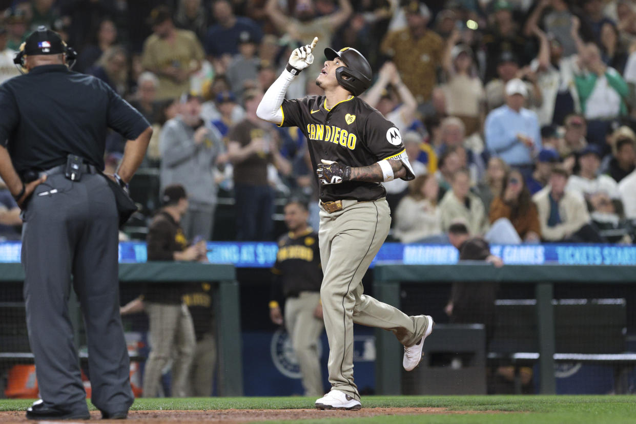 San Diego Padres' Manny Machado celebrates at home after hitting a two-run home run off Seattle Mariners starting pitcher George Kirby during the sixth inning of a baseball game, Tuesday, Sept. 10, 2024, in Seattle. (AP Photo/Jason Redmond)