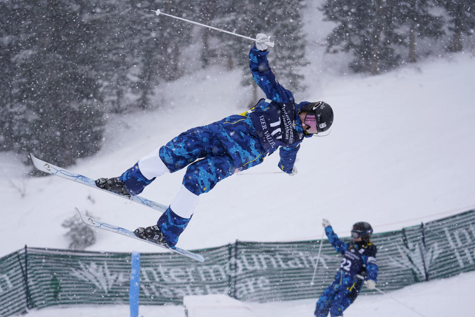 FILE - Kai Owens, left, and Olivia Giaccio compete during qualifying in the World Cup women's dual moguls skiing competition, Friday, Feb. 5, 2021, in Deer Valley, Utah. As an infant, she was abandoned at a town square in a province of China. Taken to an orphanage, she was adopted by a couple from Colorado at 16 months. Now 17, U.S. freestyle skier Kai Owens is on the verge of earning a spot in moguls for the Winter Games in Beijing. It's a return to China she's long thought about. (AP Photo/Rick Bowmer, File)