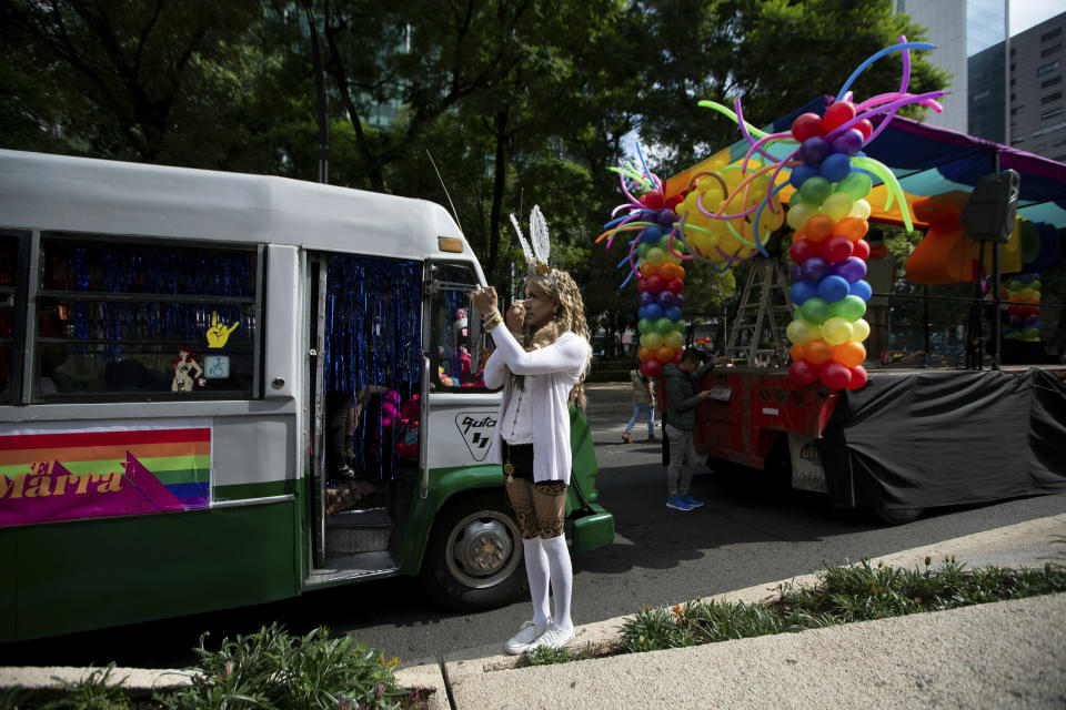 A reveler applies make up prior the gay pride parade in Mexico City, Mexico, Saturday, June 29, 2019. (AP Photo/Fernando Llano)