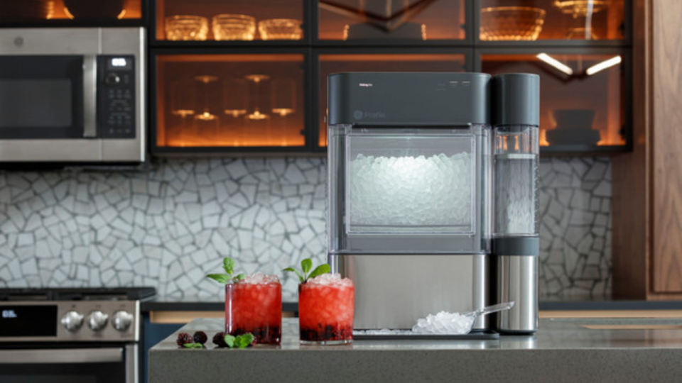 The GE Opal ice maker on a kitchen counter next to two iced drinks