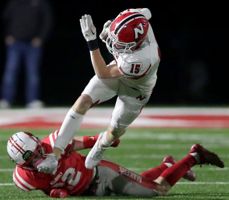 Neenah's Luke Jung (15) is tackled by Kimberly's Thomas Meyers following a reception during their Division 1 state quarterfinal football game Friday in Kimberly.