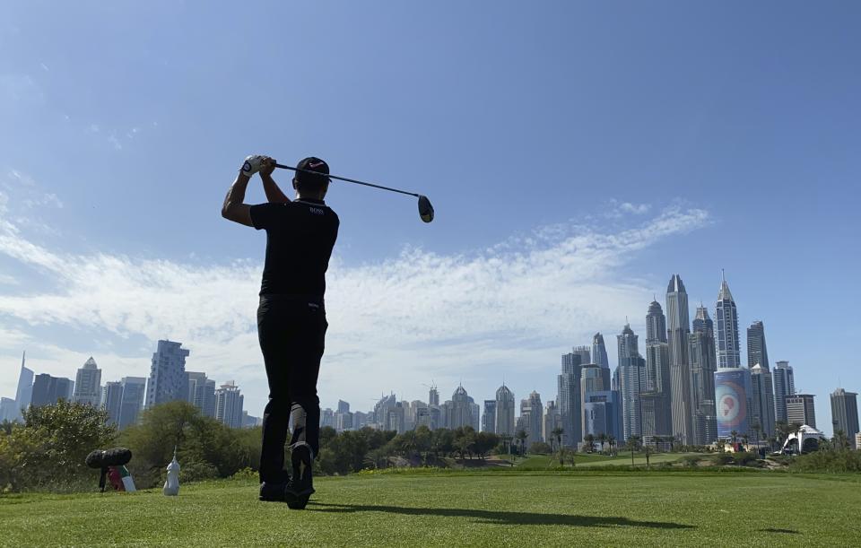 China's Ashun Wu tees off on the 8th hole during the third round of the Dubai Desert Classic golf tournament in Dubai, United Arab Emirates, Saturday, Jan. 25, 2020. (AP Photo/Kamran Jebreili)