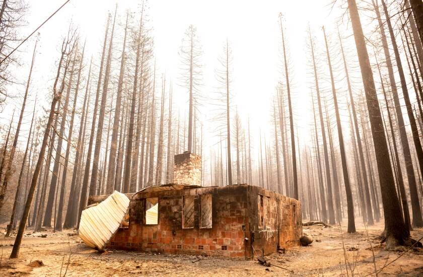 TOPSHOT - The remains of a home smolders during the Caldor fire in Twin Bridges, California on September 1, 2021. - At least 650 structures have burned and thousands more are threatened as the Caldor fire moves into the resort community of South Lake Tahoe, California. (Photo by JOSH EDELSON / AFP) (Photo by JOSH EDELSON/AFP via Getty Images)