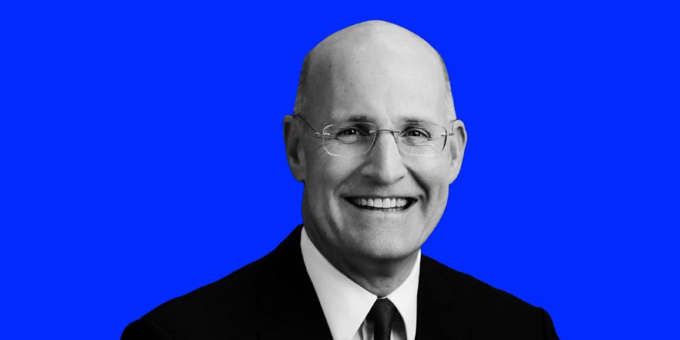 Black and white headshot of Andy Sieg wearing a suit and smiling