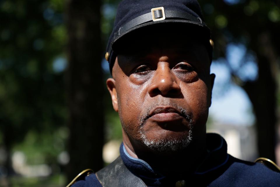 Sgt. Major Jarvis Rosier poses in his uniform as a member of the 2nd Infantry Regiment United States Colored Troops, a group that he started in Tallahassee, after the group gave a 21 gun salute and played taps during a commemorative grave decorating ceremony in honor of Emancipation Day at Old City Cemetery Monday, May 20, 2019. 