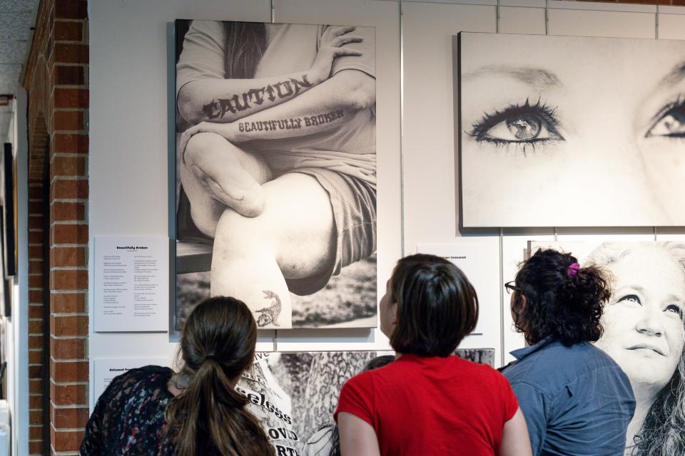 People view portraits, poetry and art of incarcerated Oklahoma women on display at the "Poetic Justice: Voices on the Inside" exhibit at Oklahoma City University's Norick Art Center in Oklahoma City.