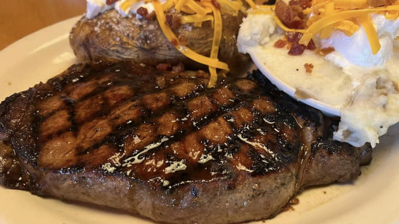 huge grilled steak with potato sides