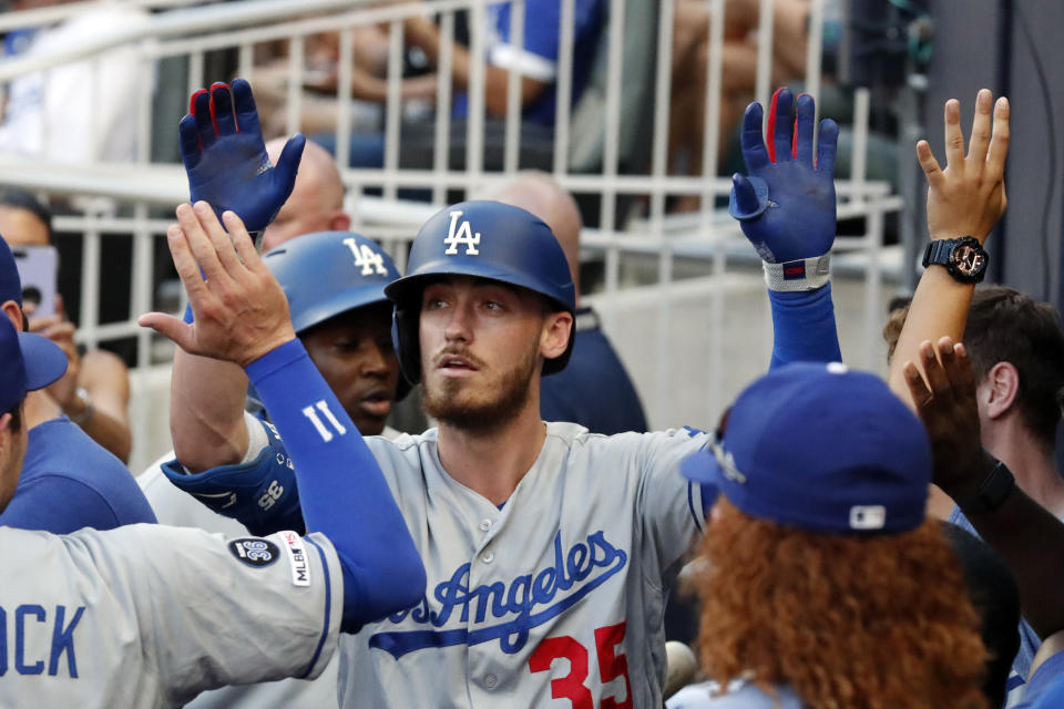 Los Angeles Dodgers right fielder Cody Bellinger (35) celebrates in the dugout after hitting a solo home run in the first inning of a baseball game against the Atlanta Braves, Friday, Aug. 16, 2019, in Atlanta. (AP Photo/John Bazemore)