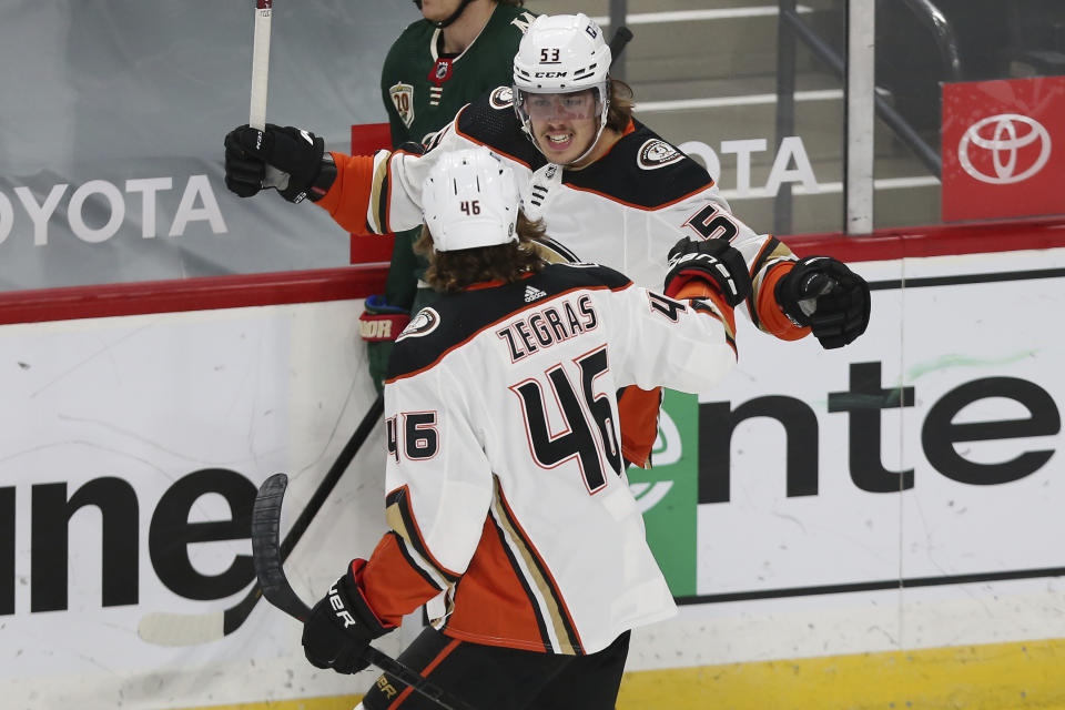 Anaheim Ducks' Max Comtois (53) celebrates with teammate Trevor Zegras (46) after scoring a goal against the Minnesota Wild during the first period of an NHL hockey game Friday, May 7, 2021, in St. Paul, Minn. (AP Photo/Stacy Bengs)