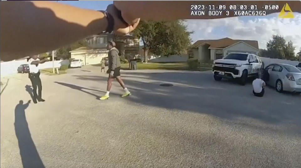 This screen grab taken from Hillsborough County police body cam video shows Hillsborough County deputies confronting suspect after he rammed his vehicles into two sheriff's deputies on Thursday, Nov. 9, 2023 in Brandon, Fla. A man intentionally drove into two sheriff's deputies on Thursday, badly injuring them before a third deputy arrested him, authorities said. (Hillsborough County Sheriff's Department via AP)