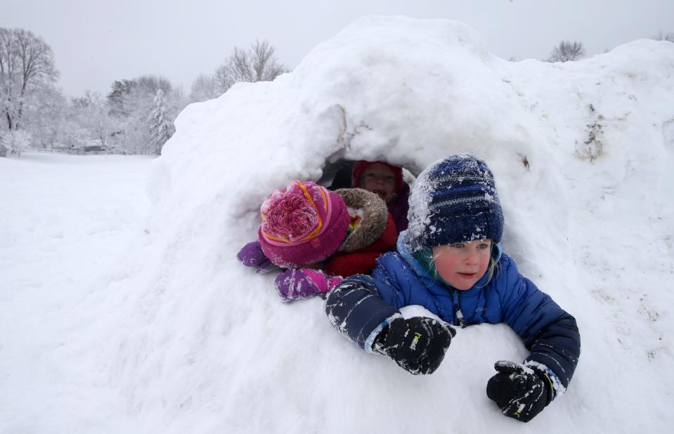Oliver Hooley, 6, peeks out of a snow structure Wednesday, Jan. 10, 2024 at Longfellow Elementary School in Iowa City, Iowa.
