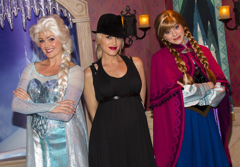 This image released by Disneyland shows musician Gwen Stefani, center, posing with Elsa the Snow Queen, left, and Anna from the Disney animated film, "Frozen," during a visit to Disneyland park in Anaheim, Calif., on Monday, Nov. 25, 2013. (AP Photo/Disneyland, Paul Hiffmeyer)