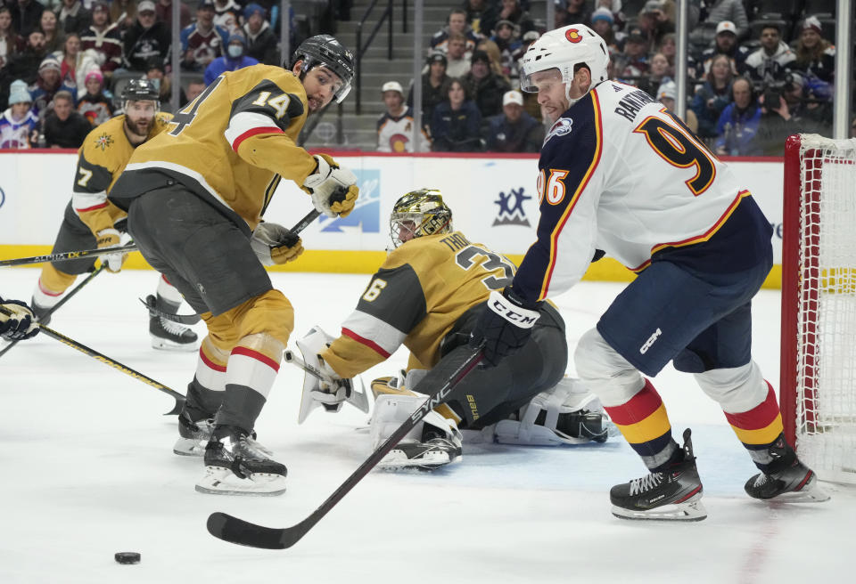 Colorado Avalanche right wing Mikko Rantanen, right, reaches out for the puck after Vegas Golden Knights goaltender Logan Thompson (36) stopped a shot as Golden Knights defenseman Nicolas Hague covers in the third period of an NHL hockey game Monday, Jan. 2, 2023, in Denver. (AP Photo/David Zalubowski)