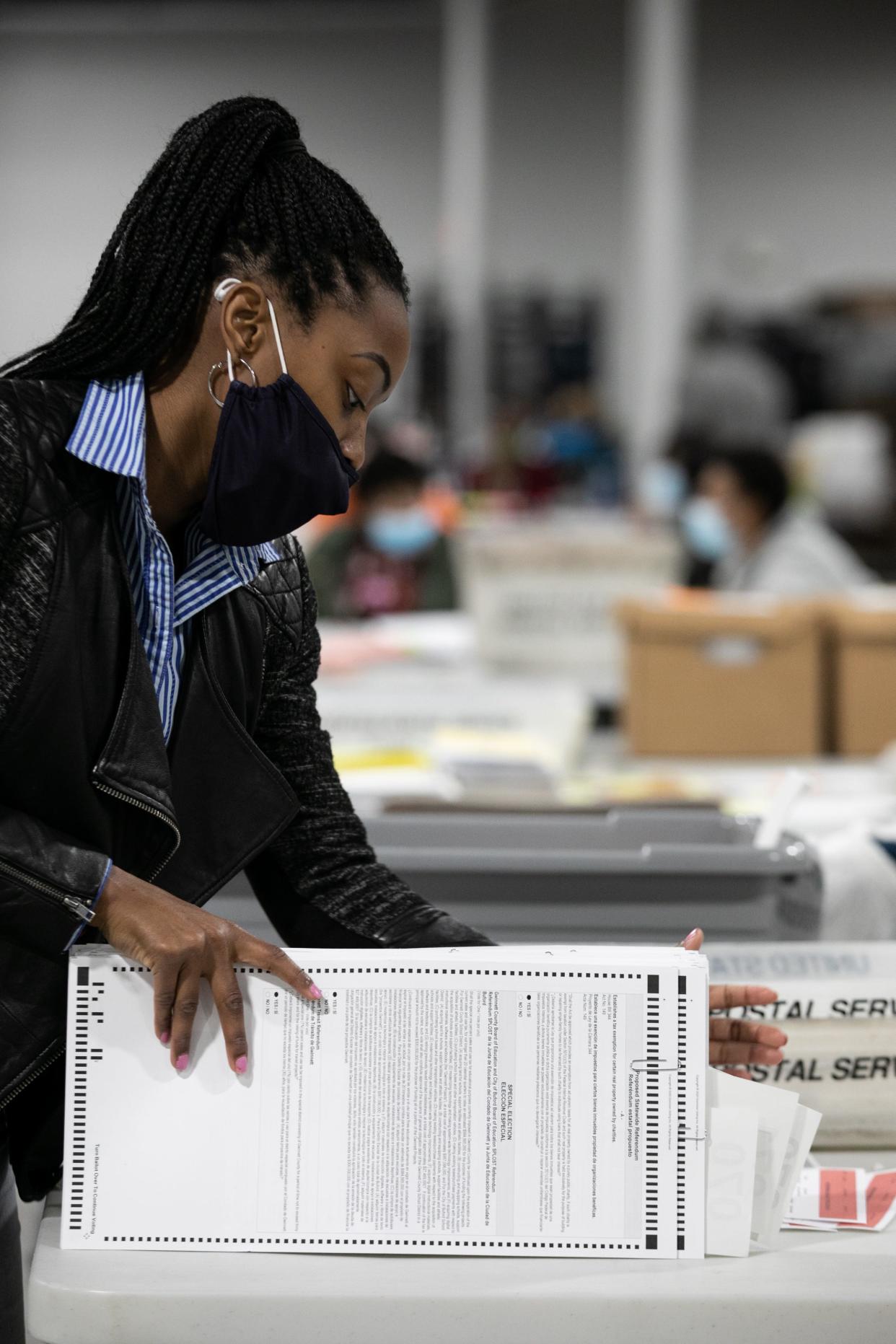 A Gwinnett County election worker processes absentee and provisional ballots on November 6, 2020 in Georgia.